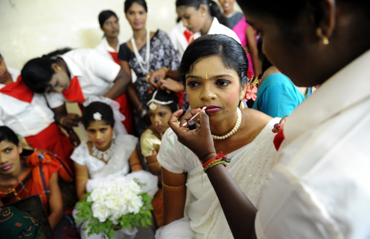 Former Tamil Tiger rebels prepare backstage during a rehabilitation official ceremony fashion show in Colombo on March 29. The program to release nearly 400 former combatants to their families. Officials said more than 10,000 ex-combatants have been rehabilitated and released to their families since the war ended in May 2009.