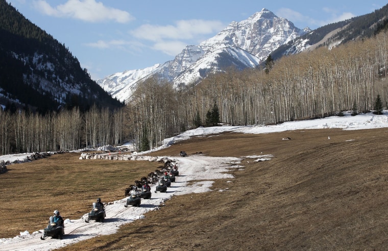 Disabled military veterans and instructors snowmobile along a tract of snow on March 29, 2012 at the T-Lazy 7 Ranch near Aspen, Colorado. Volunteers had trucked in snow for the event, due to weak snowfall this spring.