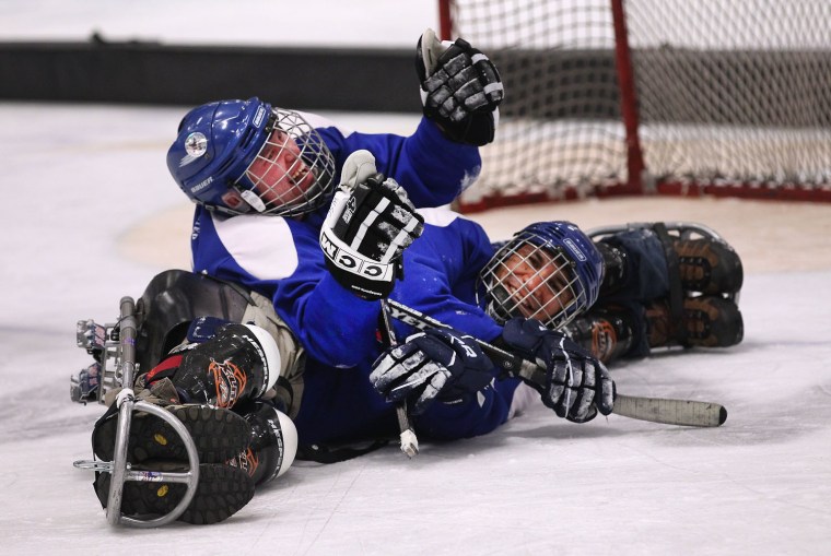 Disabled veterans collide during a sled hockey game on March 29, 2012 in Aspen, Colorado.