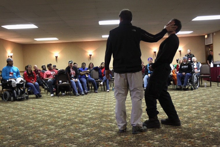 U.S. secret service agents demonstrate self-defense techniques to disabled veterans on March 28, 2012 in Snowmass Village, Colorado.