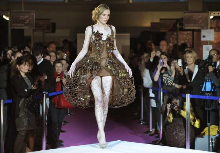 A model presents a dress made of chocolate.
