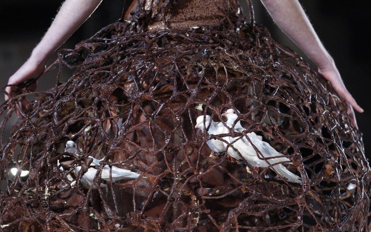 Doves are seen inside a dress made of chocolate.