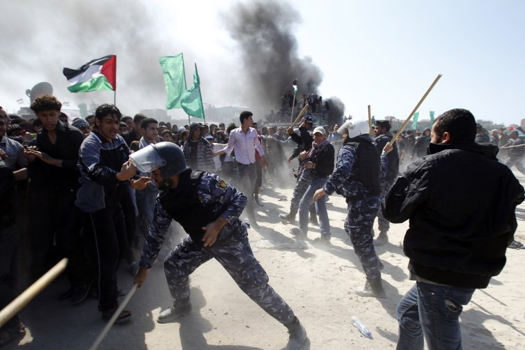 Members of the Hamas security forces prevent Palestinian protesters from reaching the border between Israel and the northern Gaza Strip, after a protest marking Land Day in Beit Hanun, on March 30. Rallies were held across the Palestinian territories including Jerusalem to mark the annual event that commemorates the deaths of six Arab Israeli protesters at the hands of Israeli forces during mass demonstrations in 1976 against plans to confiscate Arab land in northern Israel.