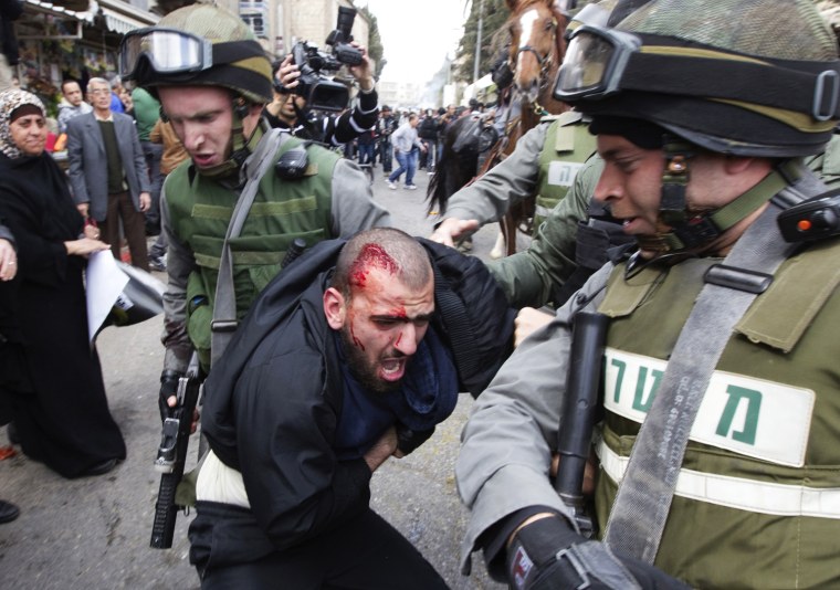 Israeli police officers detain an injured Palestinian protester during clashes on Land Day, after Friday prayers outside Damascus Gate in Jerusalem's Old City March 30. Israeli security forces fired rubber bullets, tear gas and stun grenades to break up groups of Palestinian stone-throwers on Friday as annual Land Day rallies turned violent. Police said they made five arrests at Damascus Gate. Land Day commemorates the killing by security forces of six Arabs in 1976 during protests against government plans to confiscate land in northern Israel's Galilee region.