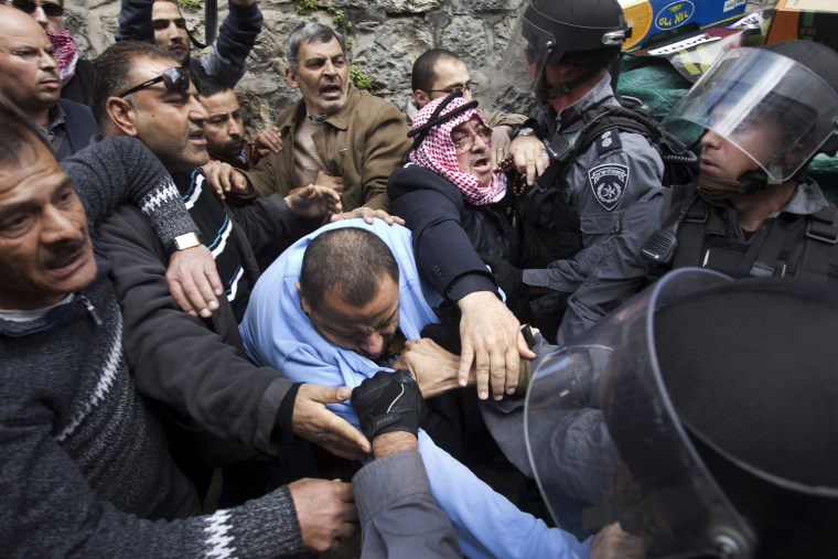 Palestinians scuffle with Israeli policemen during a demonstration marking Land Day in east Jerusalem on March 30. Demonstrators waving huge Palestinian flags gathered for Land Day, sparking scuffles with hundreds of Israeli police who were seen beating some of the crowd, an AFP correspondent said.