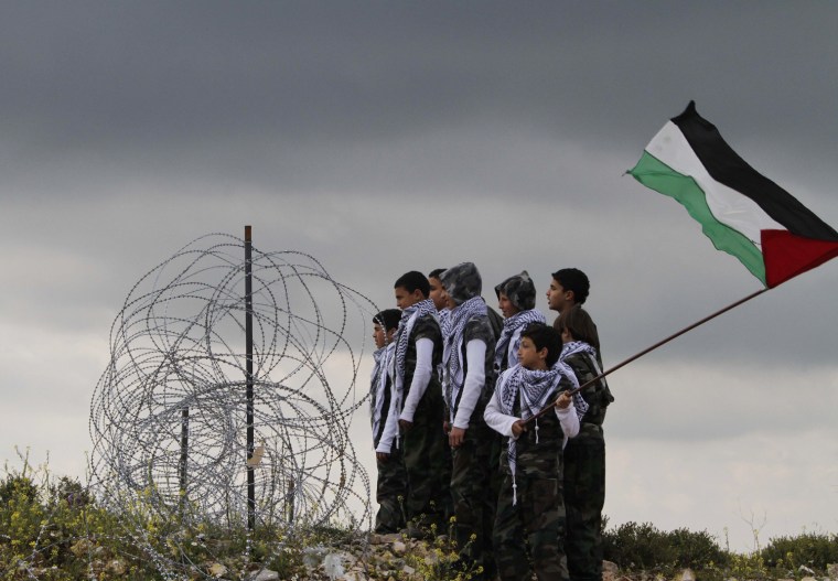 Palestinian boys look to the direction of the Lebanes-Israeli border during a Palestinian rally to mark Land Day, in the southern Lebanese village of Arnoun, Lebanon, on Friday March 30. More than 3,000 Lebanese and Palestinians gathered outside the Crusader-built Beaufort castle 9 miles from Israel. Lebanese security forces kept them from moving any closer to the border. March 30 is traditionally marked by Israeli Arabs as