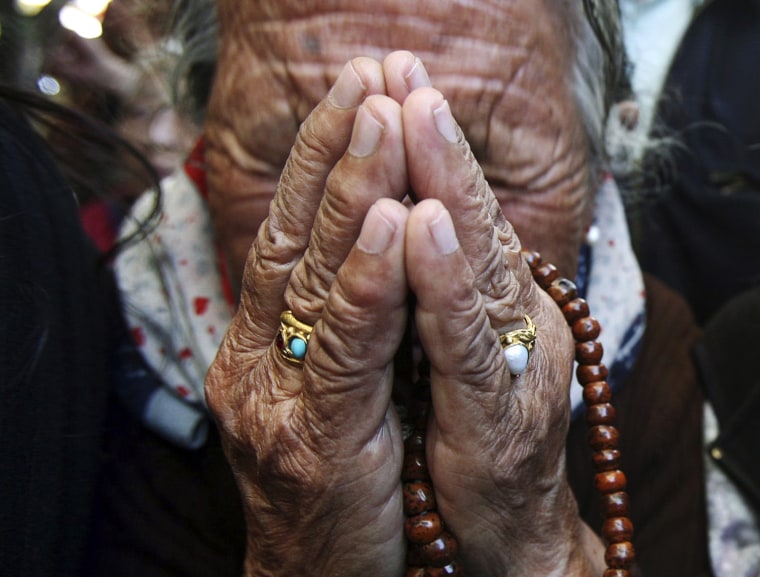 A Tibetan exile weeps as the body of Jamphel Yeshi is carried for cremation inside the Tsuglagkhang temple on March 30.