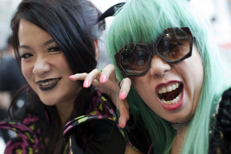 Fans of the US singer Lady Gaga, strike a pose as they arrive the venue of Lady Gaga's show in Hong Kong.