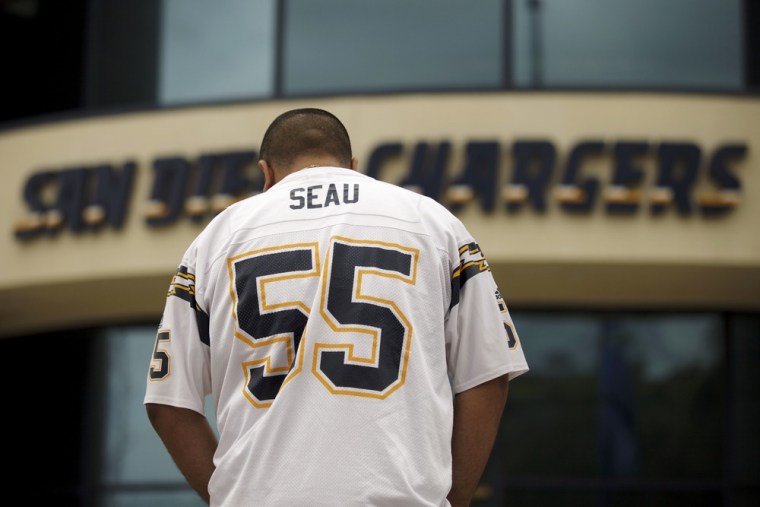 San Diego Chargers football fan Paul Camacho wears the uniform of Junior Seau as he stands in front of the team's headquarters in San Diego.