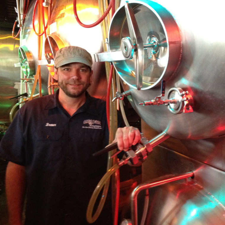 Kent Waugh, Big River brewer, poses with his serving vessels.