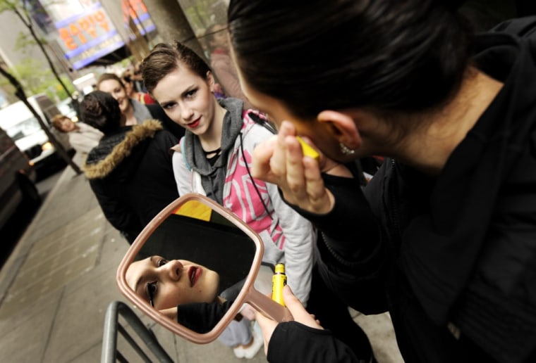 Dancer Felicia Giunta (R), of Long Island, New York, checks her make up while waiting in line for open auditions for the Rockettes dance company's 2012 Radio City Christmas Spectacular at Radio City Music Hall.
