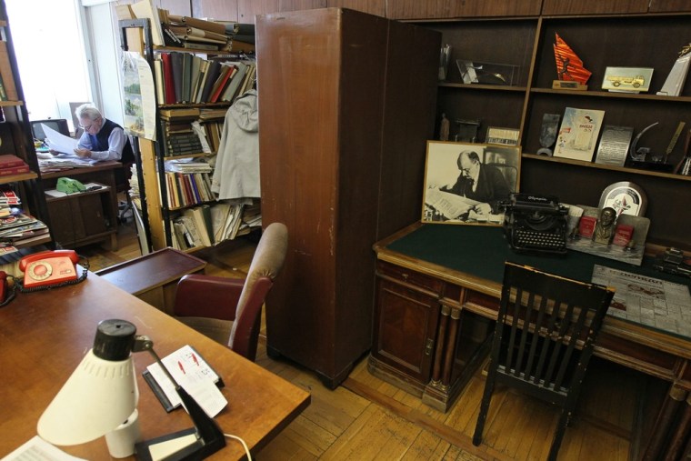 A journalist works near the memorial working place (R) of the wife of Vladimir Lenin Nadezhda Krupskaya in the editorial office of Russian Communist party newspaper 'Pravda' (Truth) in Moscow.