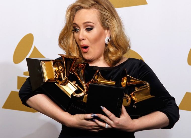 Adele holds her six Grammy Awards in Los Angeles on Feb. 12.