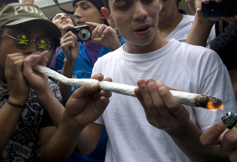 Youngsters smoke marijuana during a march for the legalization of cannabis in Medellin, Colombia on May 5, as part of the 2012 Global Marijuana March which is being held in hundreds of cities worldwide.