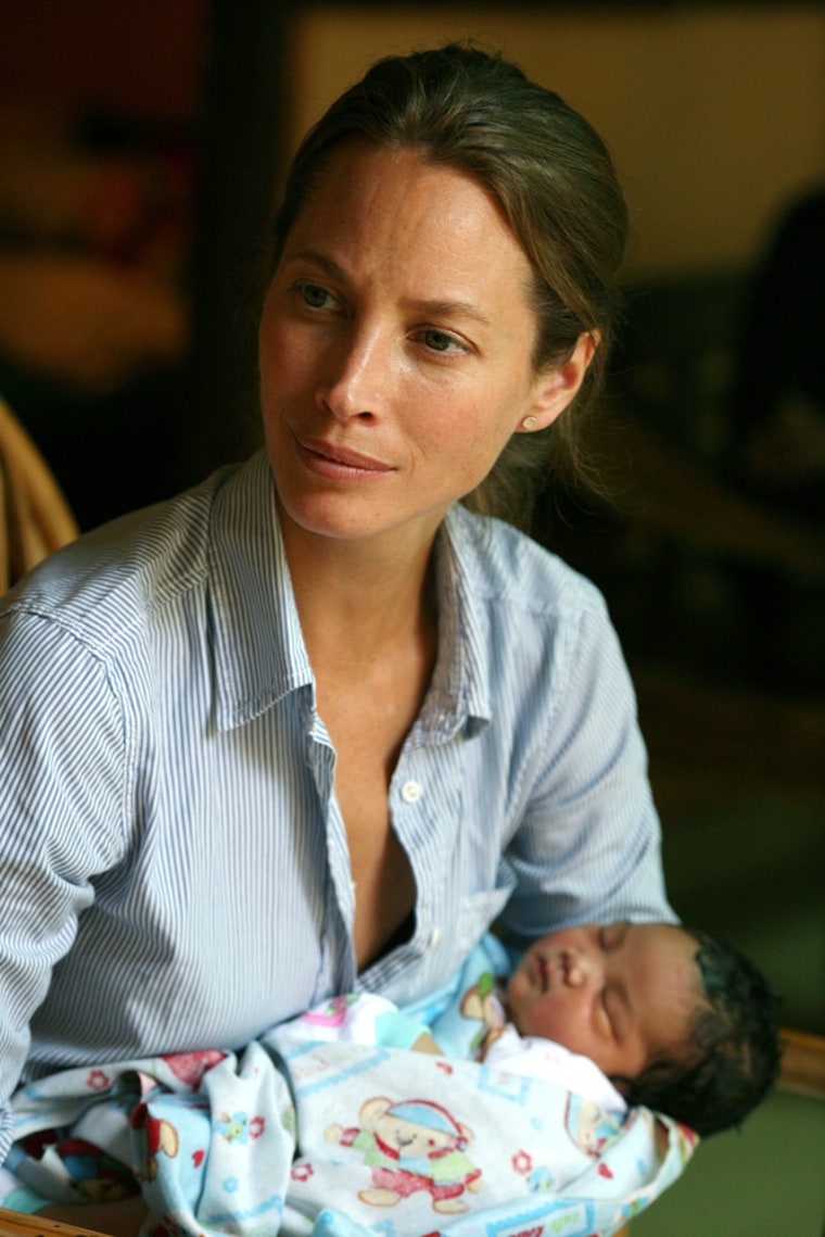 Christy Turlington Burns holds a newborn at a clinic in Bali, Indonesia.