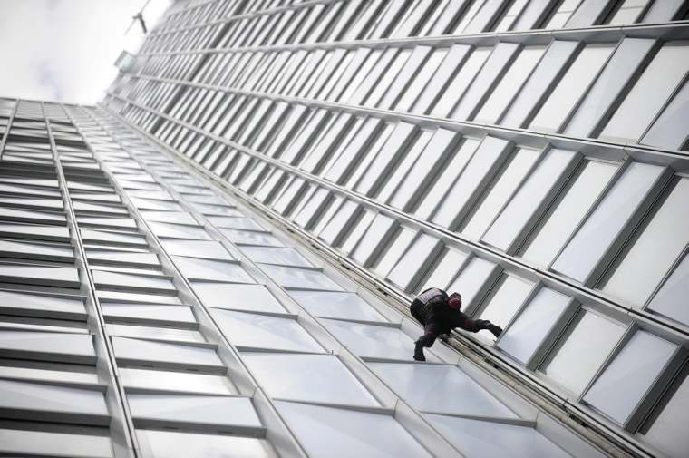 Alain Robert, who has been dubbed the 'French Spiderman,' climbs the First Tower.