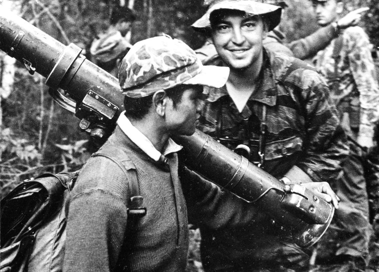 AP photographer Horst Faas, facing camera, is pictured in a jungle during the Vietnam War in 1963.