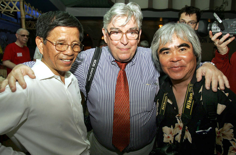 German photographer Horst Faas (C) and Vietnamese-American photographer Nick Ut (R) meet with Vietnamese photographer Dinh Dinh Phuoc during a party held, in this April 28, 2005, file photo in Ho Chi Minh-City. Ut under Faas's guidance won one of the news agency's six Vietnam War Pulitzer Prizes.