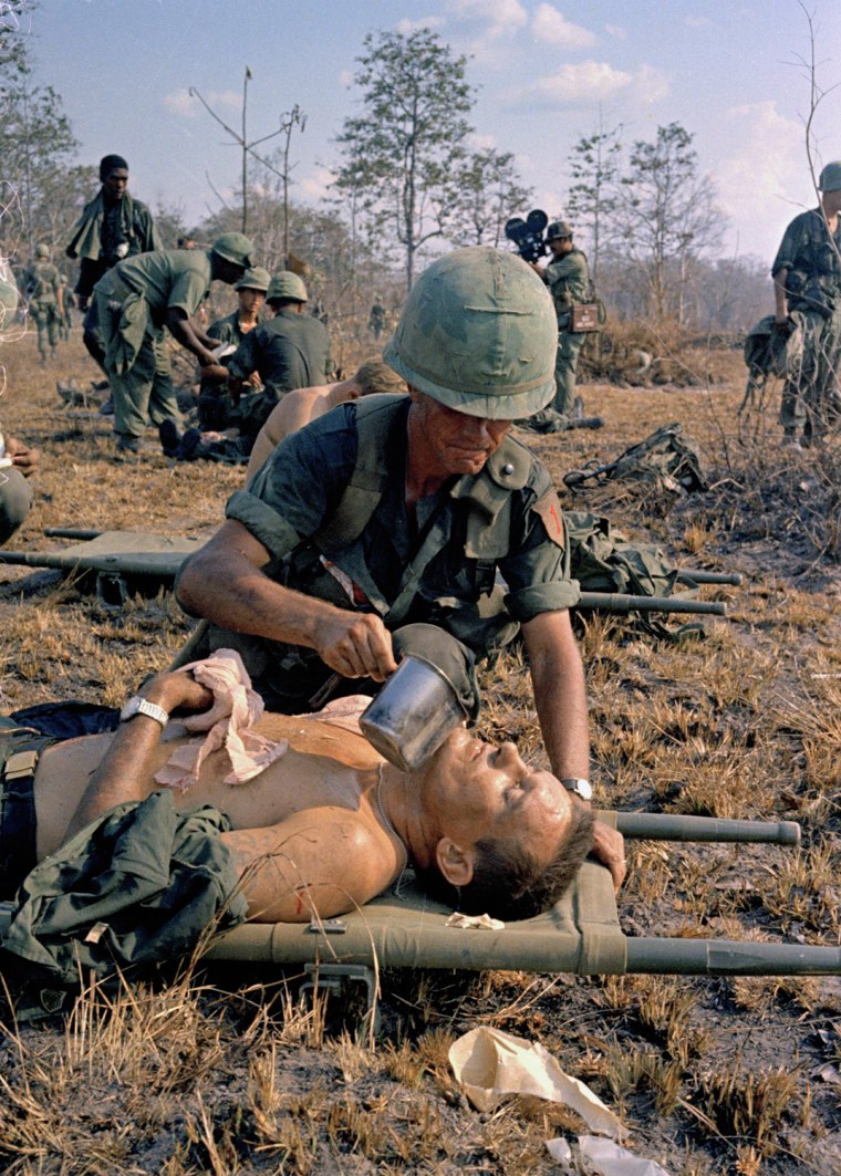 A wounded U.S. soldier is given water on a battlefield in Vietnam. Faas was best known for covering Vietnam and won four major awards including the first of his two Pulitzers.