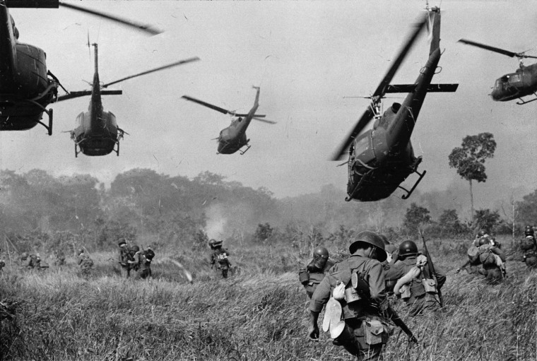 Hovering U.S. Army helicopters pour machine gun fire into the tree line to cover the advance of South Vietnamese ground troops in an attack on a Viet Cong camp 18 miles north of Tay Ninh, Vietnam, northwest of Saigon near the Cambodian border in March 1965.