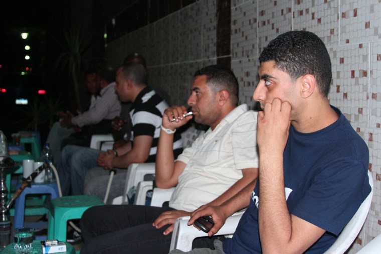 Ahmed Refai, right, and Arafa Abu El Fadel watch the debate in an outdoor cafe in Cairo on Thursday night.