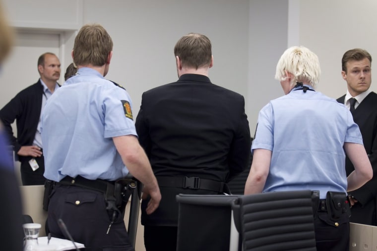 Anders Behring Breivik (center) is escorted out of court by police during his trial proceedings in Oslo, Norway, Friday.