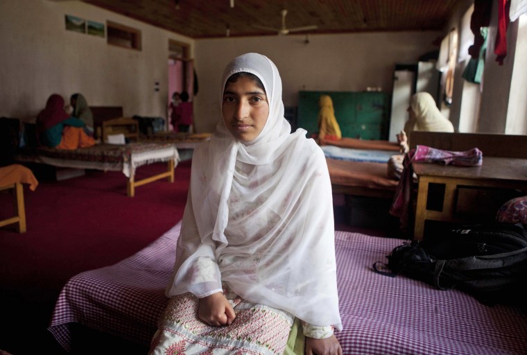 Kashmiri orphan girl Rafia Azad, who lost her father in a bomb blast, sits on her bed at Gulshan-E-Bannat Orphanage in Gopal Pora, some 10 miles west of Srinagar, India on May 9. Though there are varying statistics on the number of orphaned children in Jammu and Kashmir state, some estimates put it at around 100,000, many of them orphaned due to the armed conflict that began in 1989, according to news reports.