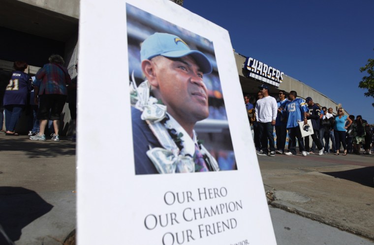 A picture of former San Diego Chargers and NFL linebacker Junior Seau is displayed as fans arrive at Qualcomm Stadium on Friday night.