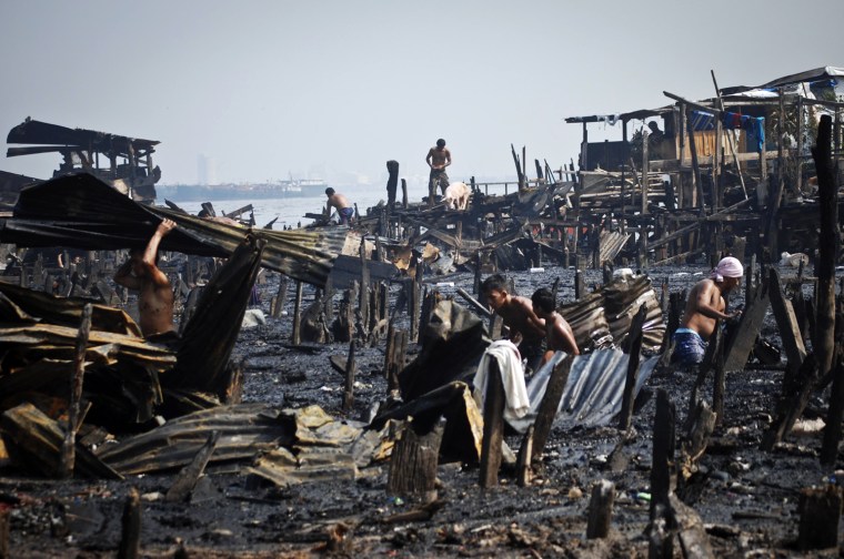Residents try to salvage recyclable materials from what used to be houses in the aftermath of a massive fire that engulfed hundreds of makeshift homes in a shanty town community in the Tondo district of Manila, Philippines, May 12.