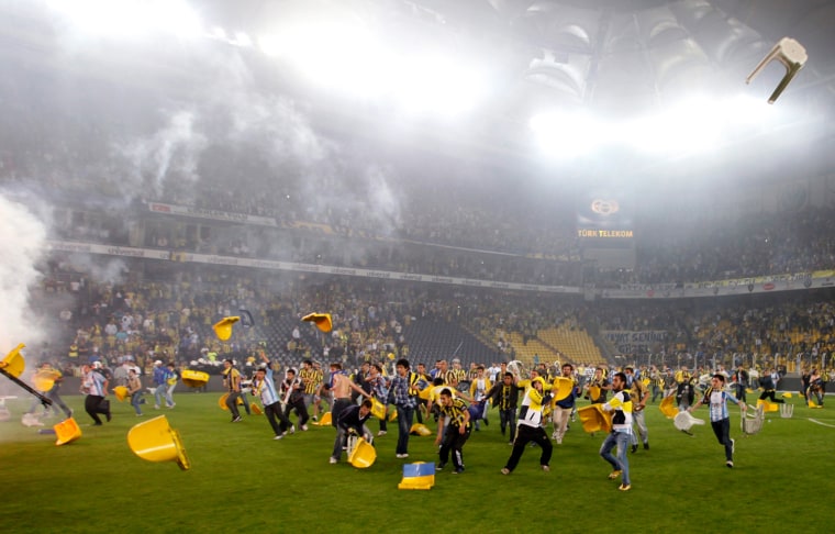 Fenerbahce soccer fans clash with riot police after their team's Turkish Super League, Super Final match against Galatasaray at Sukru Saracoglu stadium in Istanbul May 12. Galatasaray won the Turkish league title for the 18th time after a 0-0 draw at arch-rivals Fenerbahce and home fans clashed with police after Saturday's game.