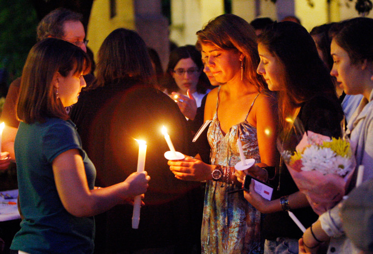 Boston University students including Tori Pinheiro, third right, of New Bedford, Mass., and Austin Brashears' girlfriend, holds a candlelight vigil on Marsh Plaza at Boston University, Saturday, May 12, in Boston, for three students studying in New Zealand who were killed when their minivan crashed during a weekend trip. Daniela Lekhno, 20, of Manalapan, N.J.; Austin Brashears, 21, of Huntington Beach, Calif.; and Roch Jauberty, 21, whose parents live in Paris, were killed as they traveled in a minivan Saturday near the North Island vacation town of Taupo when the vehicle drifted to the side of the road and then rolled when the driver tried to correct course.