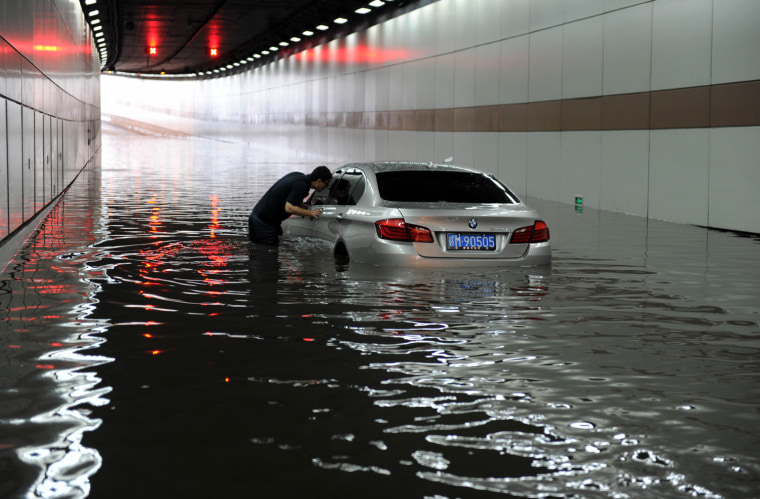 A car is stranded in a flooded tunnel after a heavy rainstorm hit China's Jiangxi Province on May 12, flooding roads in several cities.