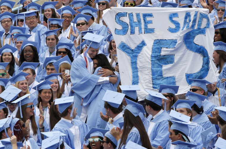 Maura Mayorga, standing right, and Michael Wengenroth embrace after getting engaged during the University of North Carolina's 2012 commencement in Chapel Hill, N.C., May 12. About 5,700 students graduated.