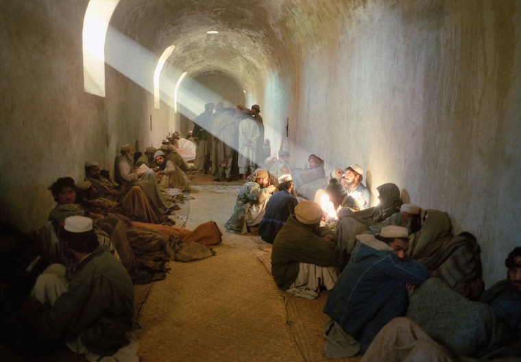 Pakistani militants are held in a makeshift prison after being captured for illegally entering Afghanistan. The Afghan authorities later released them on a Ramadan amnesty. December 2001