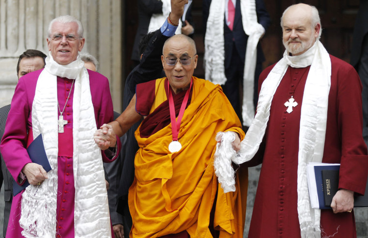 Dalai Lama, Tibetan Buddhist spiritual leader, center, with Bishop of London Richard Chartres, right, and St.Paul's Cathedral Canon Pastor Reverend Michael Colclough as he leaves St. Paul's Cathedral in London after receiving the 2012 Templeton Prize awarded to him for encouraging scientific research and harmony among religions, on May 14.