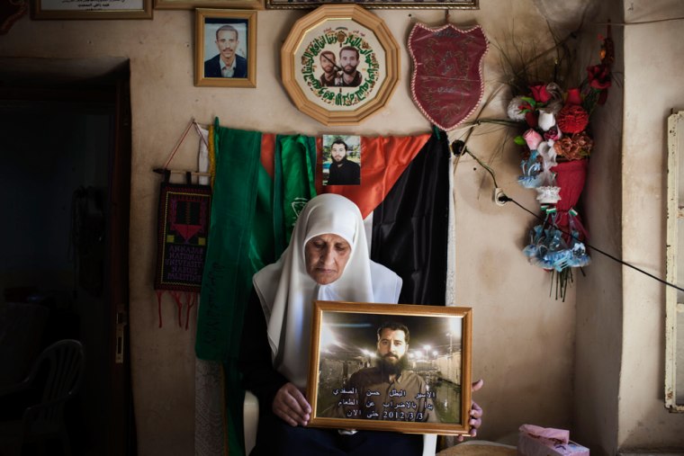 Harbiya al-Batall holds a picture of her 33-year-old son Hasan Safadi at their family home in the West Bank city of Nablus May 11, 2012. Hasan Safadi was arrested on June 29 and is held without charges since. Hasan has been on a hunger strike since March 3, 2012.