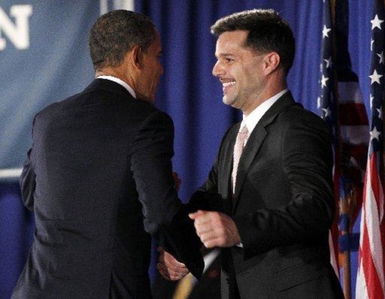 President Barack Obama, left, is introduced by singer Ricky Martin, right, at a fundraiser hosted by Martin and the LGBT Leadership Council at the Rubin Museum of Art, Monday, May 14, 2012, in New York.