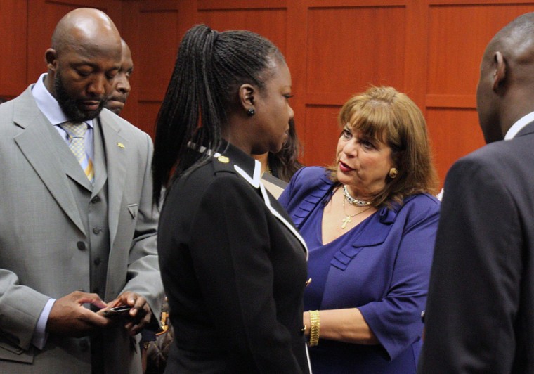The parents of Trayvon Martin, Tracy Martin, left, and Sybrina Fulton, second from left, meet with prosecutor Angela Corey as they arrive with their attorney Benjamin Crump, right, at the Seminole County Courthouse in Sanford, Fla., on April 20. Tracy Martin and Fulton are among the witnesses whose names were made public in a court filing by Corey on Monday.