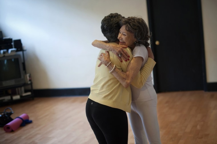 Yoga instructor Tao Porchon-Lynch hugs one of her students after leading a class.