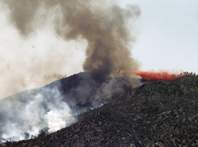 An air tanker drops retardent on a fire Monday, May 14, 2012, near Crown King, Ariz.