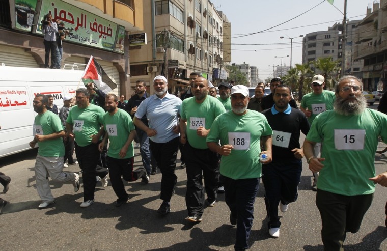 The head of Gaza's Hamas government, Ismail Haniya (blue polo shirt), takes part in a marathon in Gaza City on May 15, 2012 to mark Nakba day.