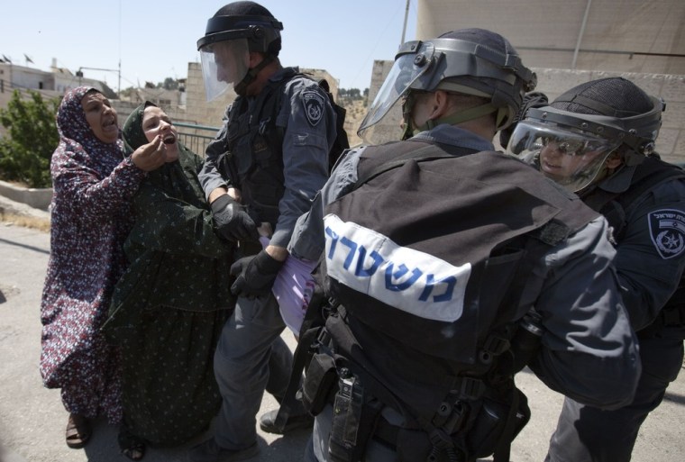 Palestinian women scuffle with Israeli policemen as they try to stop them from arresting a relative in the east Jerusalem Arab neighborhood of Issawiya on May 15, 2012, as Palestinians took to the streets to mark Nakba day.