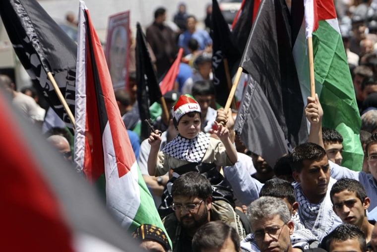 A boy holds up a door key as Palestinians take part in a rally marking Nakba in the West Bank city of Ramallah on May 15, 2012.