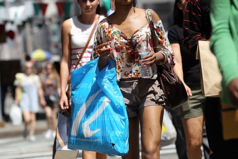 A pedestrian carries a shopping bag while walking along Broadway on April 16, 2012 in New York City.