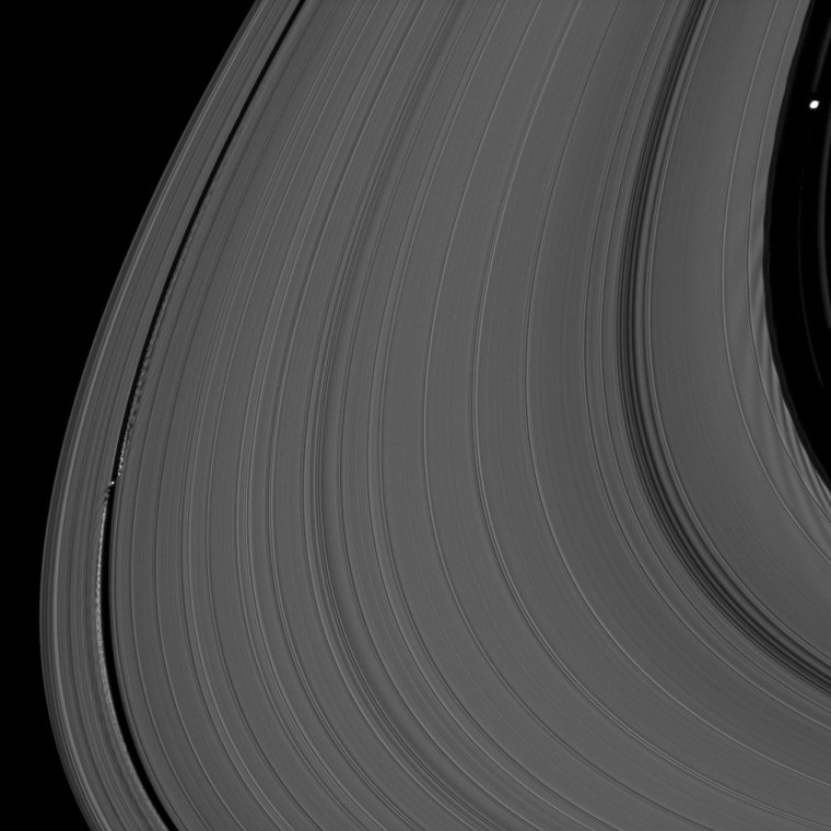 The Saturnian moon Daphnis and Pan stir ripples in the giant planet's rings due to their gravitational effect. Five-mile-wide Daphnis (lower left) is perturbing particles in Saturn's A ring, while 17-mile-wide Pan (upper right) has kicked up dark wakes in the ring propagating toward the middle of the image. This picture was taken in visible light by the Cassini spacecraft's narrow-angle camera on June 3, 2010, at a distance of about 329,000 miles from Saturn.