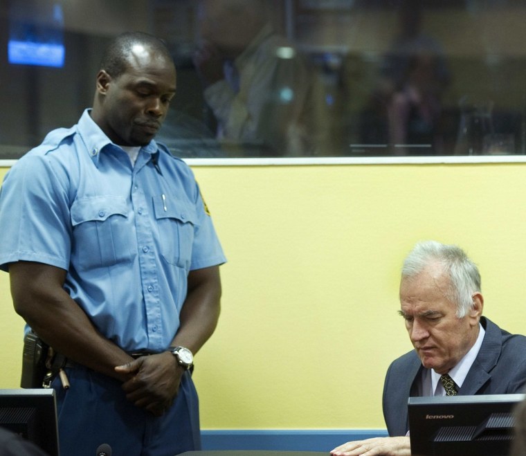Former Bosnian Serb army chief Ratko Mladic sits in a courtroom in The Hague on Wednesday as his trial opens. Mladic, 70, faces 11 overall counts for genocide, war crimes and crimes against humanity.