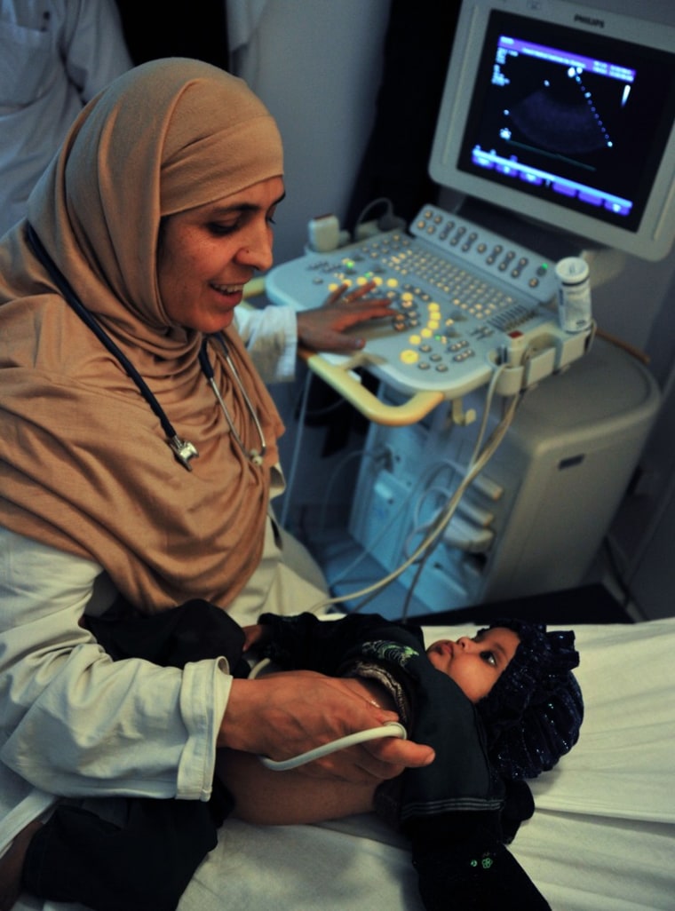 Rahima Stanikzair monitors an infant's heart at the French Medical Institute for Children (FMIC) in Kabul on May 13, 2012.