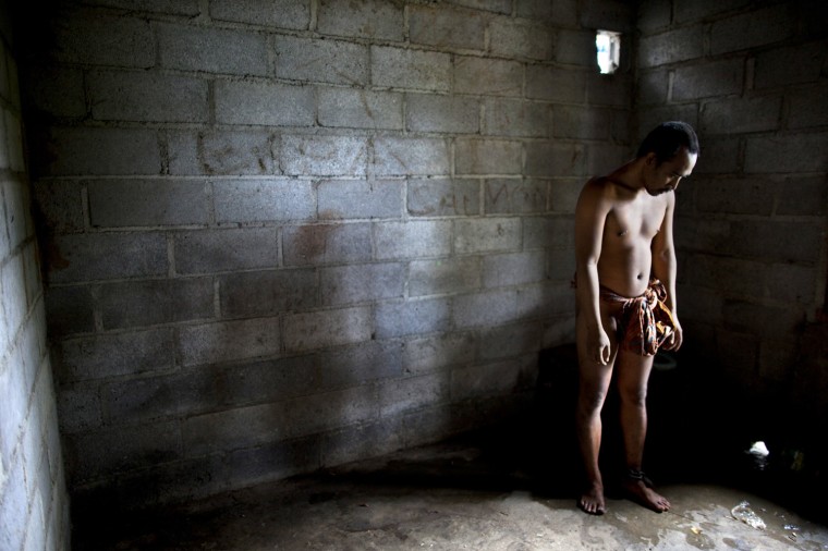 Gede, 28, stands in his room inside the home of his family where he has been chained for years on May 5 in Buleleng, Bali, Indonesia. Gede went to school for nine years and has been to the mental hospital twice but escaped in 2006.