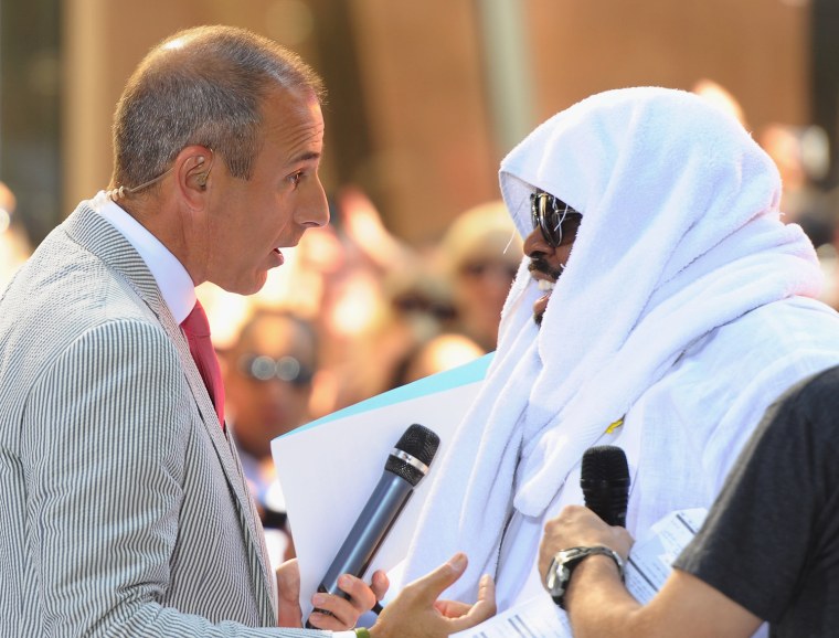 Anchorman Matt Lauer talks with singer Cee Lo Green during Green's performance on NBC's \"Today\" at Rockefeller Center on July 22, 2011 in New York City.