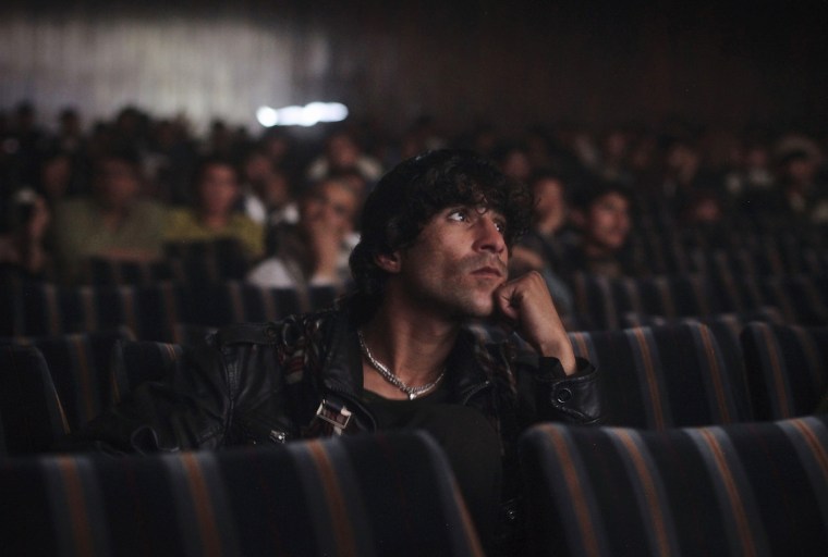A cinema goer watches a Pashto film at Cinema Pamir in Kabul on May 3.